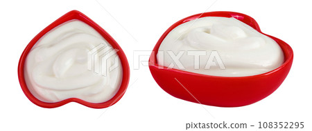 sour cream or yogurt in red ceramic bowl heart shaped isolated on white background with full depth of field. Top view. Flat lay 108352295