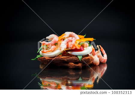 cooked sandwich with shrimp, eggs, pepper and greens cooked sandwich with shrimp, eggs, pepper and greens 108352313