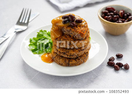 Vegan bean burgers with gravy sauce, patties or cakes, healthy alternative food 108352493
