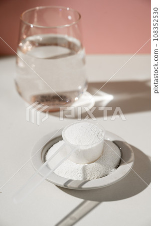 Collagen protein powder and glass of water. Food beauty and health supplement Collagen protein powder and glass of water. Food beauty and health supplement 108352530