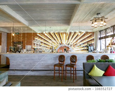 restaurant bar counter with empty chairs and alcoholic drinks on the counter restaurant bar counter with empty chairs and alcoholic drinks on the counter 108352727