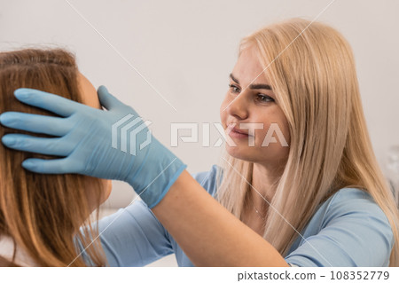 Instant harmony: The photo captures an important moment of a woman's meeting with a professional cosmetologist in a beauty salon. Individual approach: The client talks to a cosmetologist in a spa Instant harmony: The photo captures an important moment of a woman's meeting with a professional cosmetologist in a beauty salon. Individual approach: The client talks to a cosmetologist in a spa 108352779