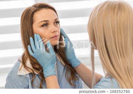 Steps to perfection: Cosmetology consultation from a professional from a beauty clinic to unleash the potential of skin beauty. Professional care: The patient interacts with a cosmetologist, who 108352780