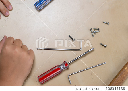 master repairs the iron in the workshop on the table using tools master repairs the iron in the workshop on the table using tools 108353188