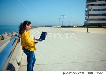 Freelancer woman using laptop, talks with her colleagues via video link. Online communication. Internet business concept Freelancer woman using laptop, talks with her colleagues via video link. Online communication. Internet business concept 108353564