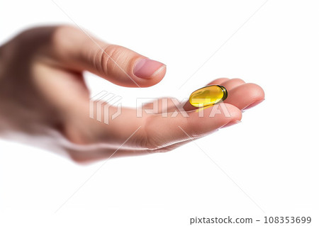 Fish oil capsule in a female hands isolated on white background Fish oil capsule in a female hands isolated on white background 108353699
