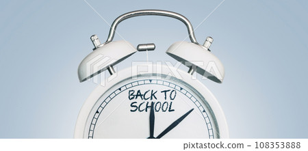 Vintage alarm clock showing back to school arrows. Beginning of the school season. Education. Students start. School and clock, concept Vintage alarm clock showing back to school arrows. Beginning of the school season. Education. Students start. School and clock, concept 108353888