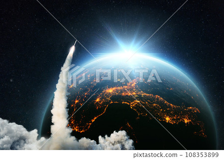 Space Rocket lift off. Space shuttle with smoke and blast takes off into space on a background of blue planet earth with amazing sunset. Successful start of a space mission. Travel to Earth. Space Rocket lift off. Space shuttle with smoke and blast takes off into space on a background of blue planet earth with amazing sunset. Successful start of a space mission. Travel to Earth. 108353899