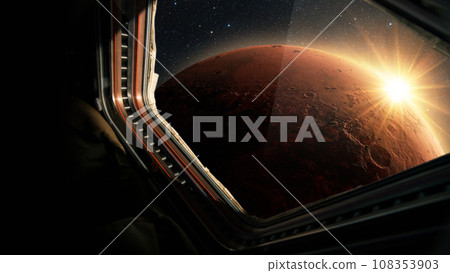 Spaceship flies near the amazing red planet Mars, view from the window. Travel and tourists in space, concept. Beautiful space view of the Mars with sunset. Hotel in space 108353903