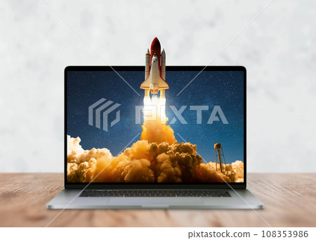 Laptop on the desktop and the space shuttle rocket successfully takes off beyond the frames of display. Start up and success, creative idea. Development, marketing and application, Concept 108353986