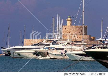 Old stone lighthouse on the breakwater in Rhodes. Old stone lighthouse on the breakwater in Rhodes. 108354091