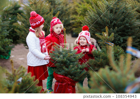 Kids buying Christmas tree 108354943