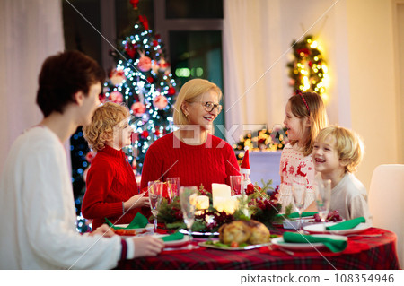 Christmas dinner. Family with kids at Xmas tree. 108354946