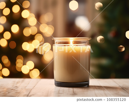 Holiday candle commercial, front view of burning candle in glass jar mock-up on Christmas background with winter decorations and bokeh 108355120