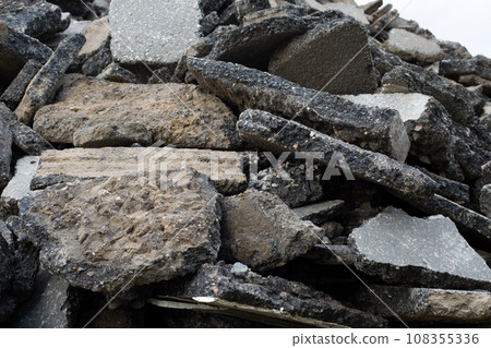 Pieces of chopped raw asphalt in a pile on a construction site, close up 108355336