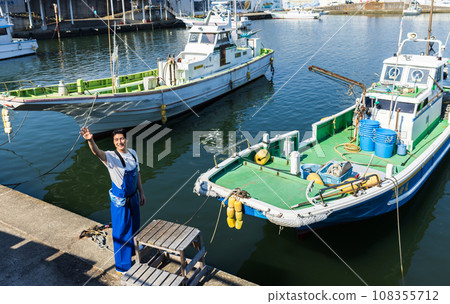 Young fishermen standing at the fishing port Young fishermen standing at the fishing port 108355712