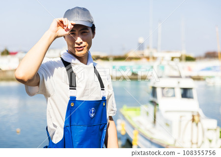 Young fishermen standing at the fishing port 108355756