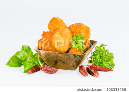 Breaded chicken nuggets. Breaded Chicken Inner Fillet with green lettuce leaves on a White Background,Chicken Breaded Raw Meat,Fillet.Fast homemade food at home.Chicken breaded schnitzels.Fast cooking 108355966