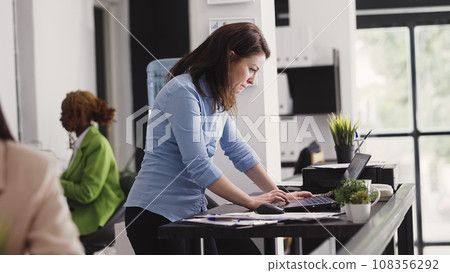 Business manager working with executive data on pc, planning corporate report in startup office. Young entrepreneur analyzing statistics for company development, investment plan. Handheld shot. Business manager working with executive data on pc, planning corporate report in startup office. Young entrepreneur analyzing statistics for company development, investment plan. Handheld shot. 108356292