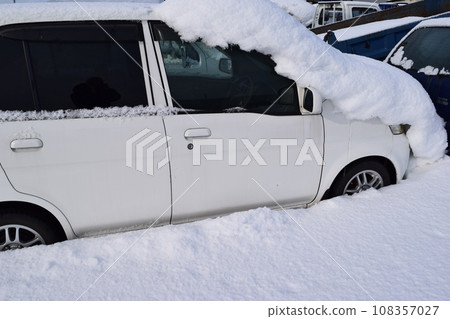 A car buried in heavy snow A car buried in heavy snow 108357027
