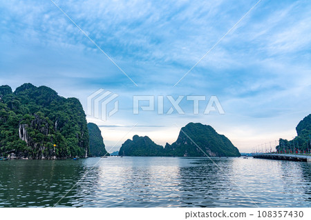 Strangely shaped rocks and fishing boats in Ha Long Bay, Vietnam Strangely shaped rocks and fishing boats in Ha Long Bay, Vietnam 108357430
