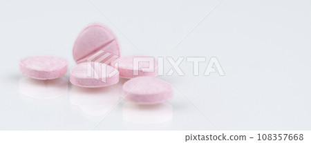 Pink tablets pills on white background. Health and medical care concept. Pharmacy banner. Prescription drug. Pharmaceutical industry. Medical center banner. Vitamins, minerals and supplements concept. 108357668