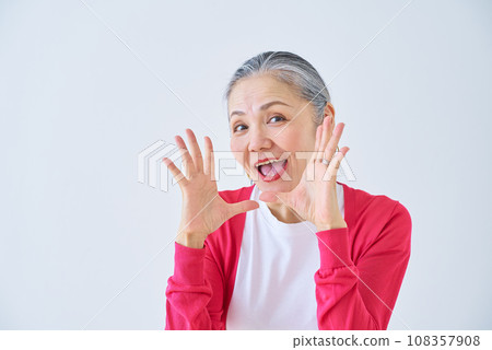 Senior woman cheering Senior woman cheering 108357908