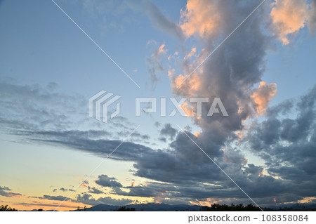 The majesty of the clouds and the beauty of the rays of light at sunset against the blue sky The majesty of the clouds and the beauty of the rays of light at sunset against the blue sky 108358084