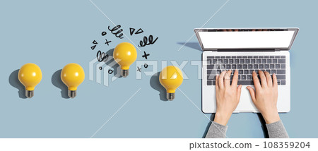 Idea light bulbs with person using a laptop computer 108359204