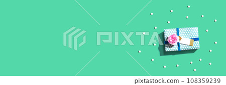 Gift box with carnation flower overhead view 108359239