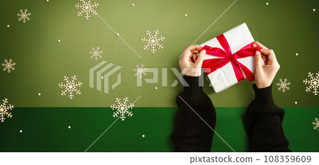 Person making a Christmas gift box Person making a Christmas gift box 108359609