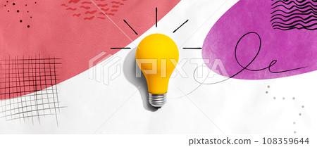 Yellow light bulb with handwritten sketch 108359644
