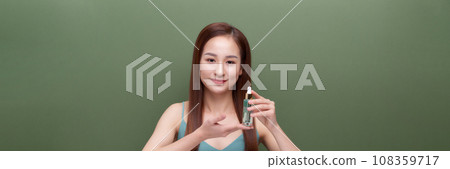 Crop young female applying serum on face, banner 108359717