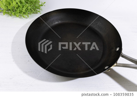 A well-used iron pan coated with oil. Popular for iron supplementation. A well-used iron pan coated with oil. Popular for iron supplementation. 108359835