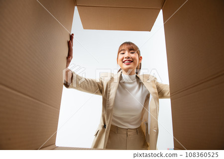Woman with open box, view from inside. Surprise. Woman with open box, view from inside. Surprise. 108360525