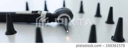 Modern otoscope with light on tip and caps for ear checkup 108361578