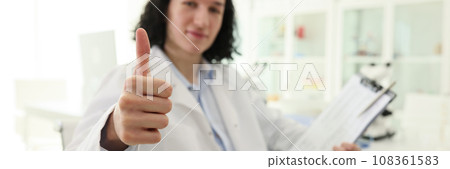 Satisfied male laboratory worker shows thumb up gesture 108361583