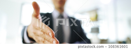 Office worker in business suit extends hand for handshake 108361601