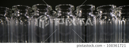 Empty vials for vaccines stand in row on dark background Empty vials for vaccines stand in row on dark background 108361721