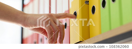 Hand of secretary taking yellow folder with archive files 108362060