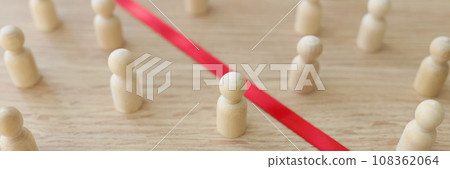 Red strip divides wooden figurines of opponents on table Red strip divides wooden figurines of opponents on table 108362064