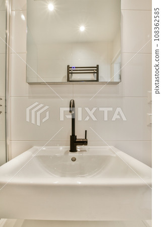 a bathroom with a sink and mirror on the wall next to it is an image of a glass shower door a bathroom with a sink and mirror on the wall next to it is an image of a glass shower door 108362585