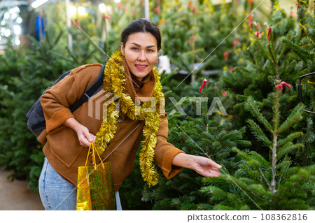 Woman purchasing christmas tree 108362816