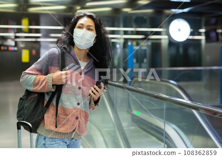 Woman walking at hall of subway station 108362859