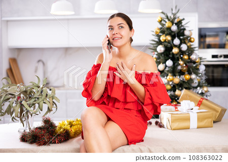 Talking on phone, girl shares plans for New Year 108363022