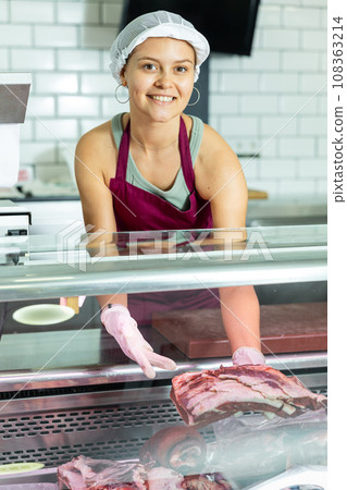 Girl seller works in specialized butcher shop Girl seller works in specialized butcher shop 108363214