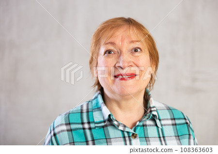 Smiling elderly woman in plaid shirt looking at camera 108363603