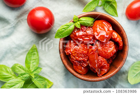 Bowl with sun dried tomatoes with fresh herbs and spices. Bowl with sun dried tomatoes with fresh herbs and spices. 108363986