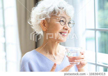 Senior woman relaxing by the window 108364313