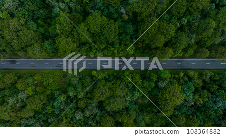 Aerial view over forest road with asphalt road and forest, Road in the middle of the forest up to mountain, Countryside road passing through the green forrest and mountain. Aerial view over forest road with asphalt road and forest, Road in the middle of the forest up to mountain, Countryside road passing through the green forrest and mountain. 108364882